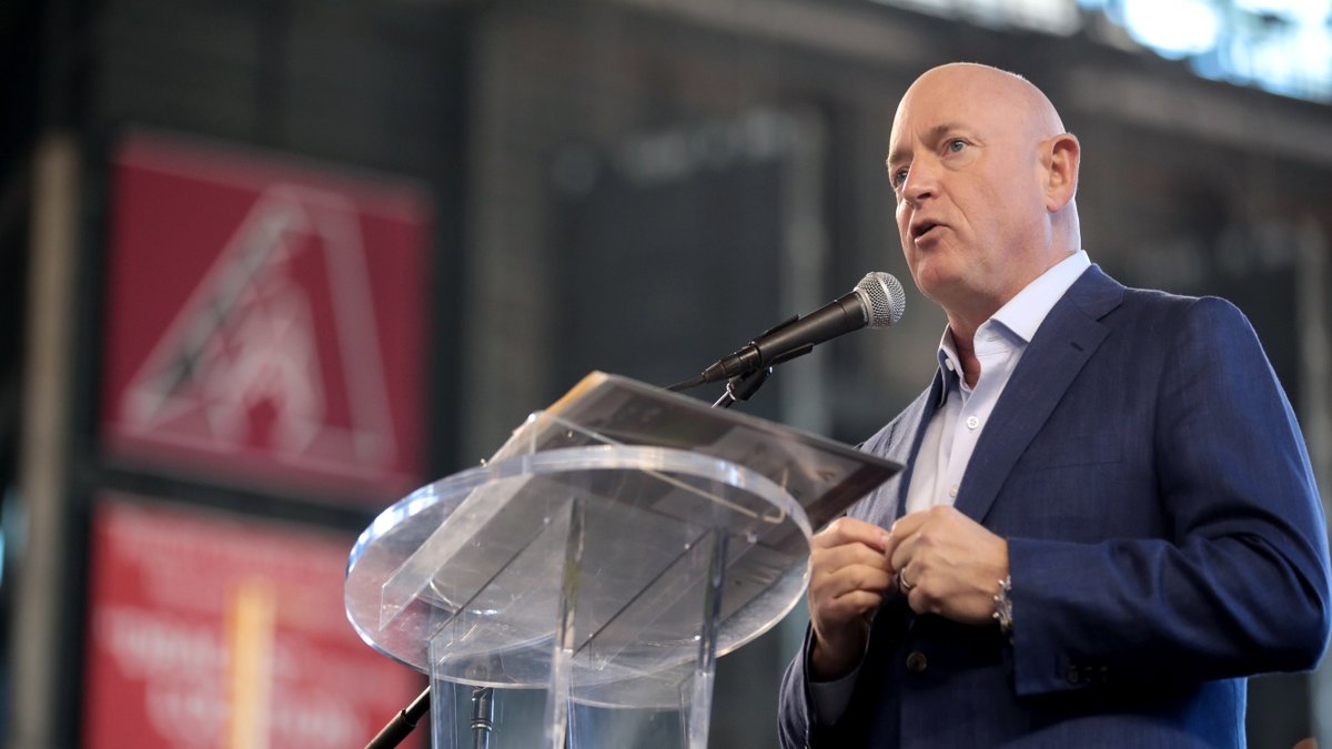 Sen. Mark Kelly speaks at a podium.