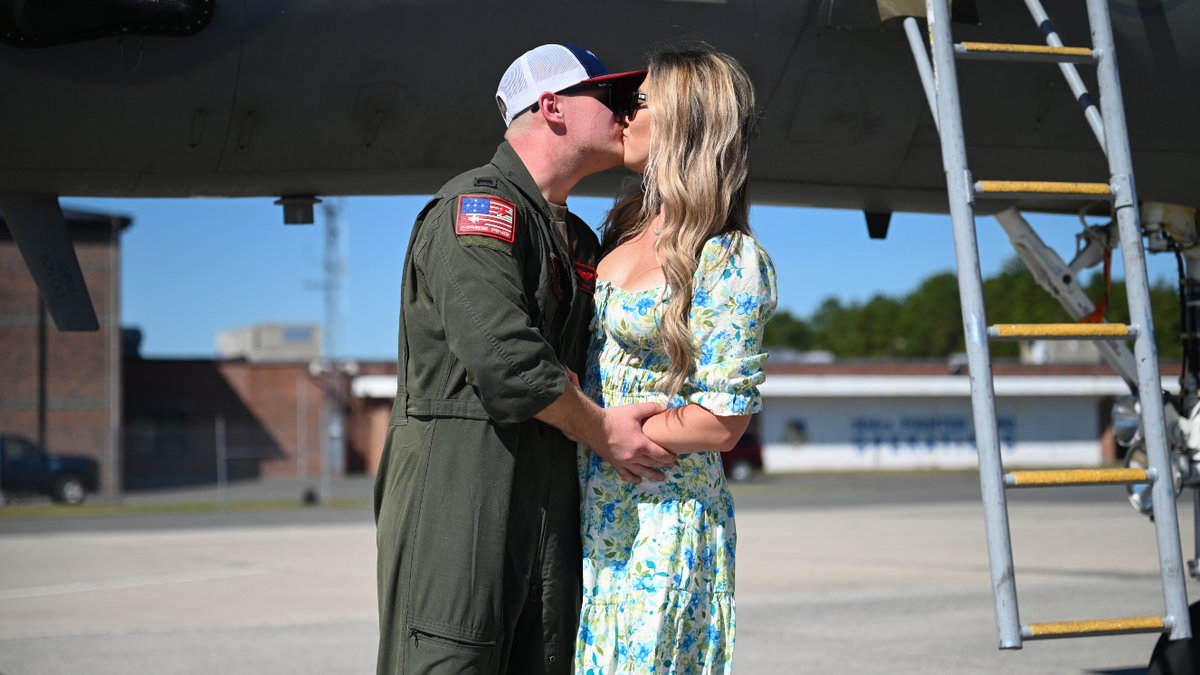 A couple kissing upon greeting each other.