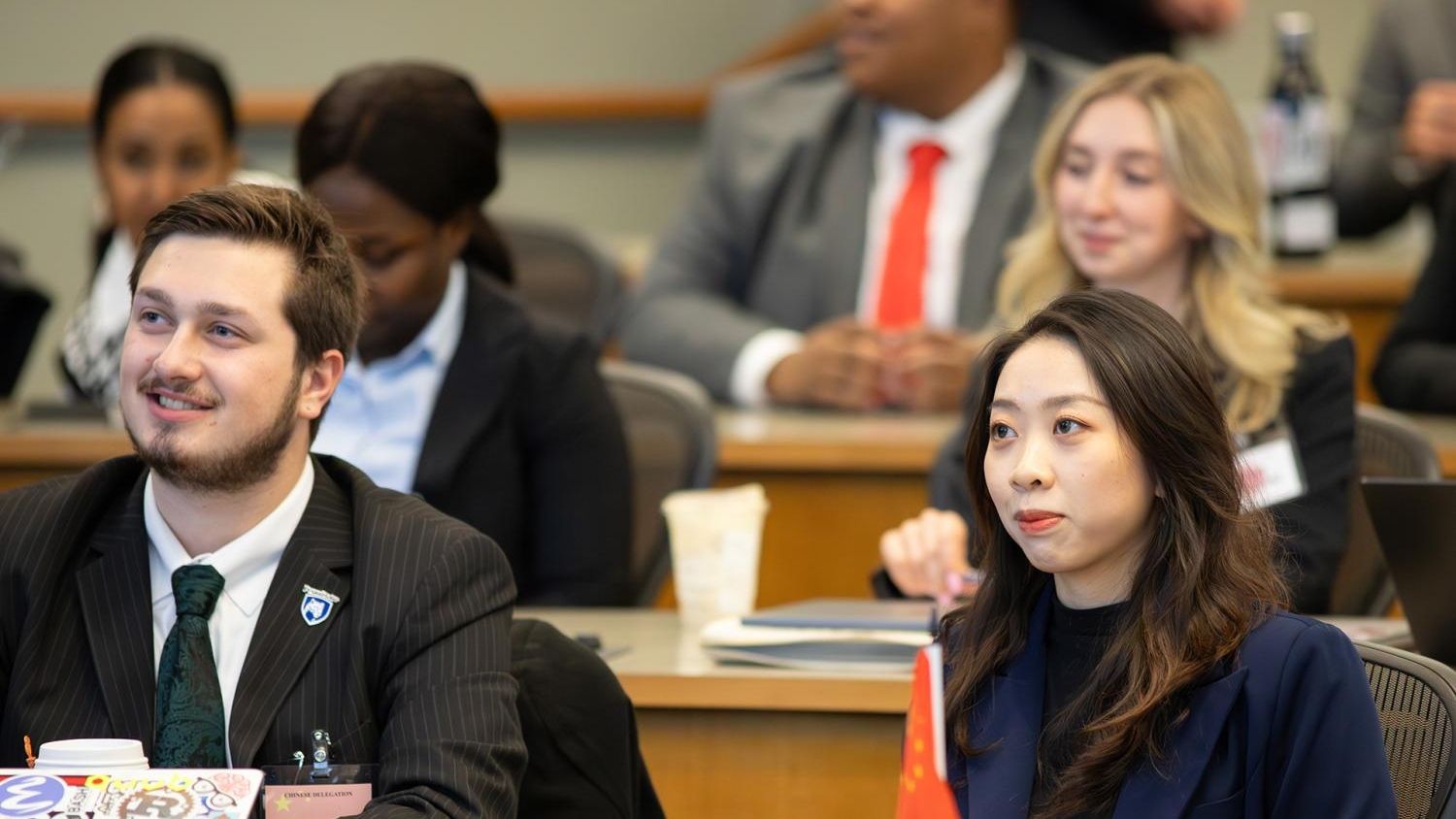 Graduate students sit in class.