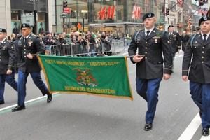 Members of the 69th Regiment hold a banner and march on S. Patrick's Day.