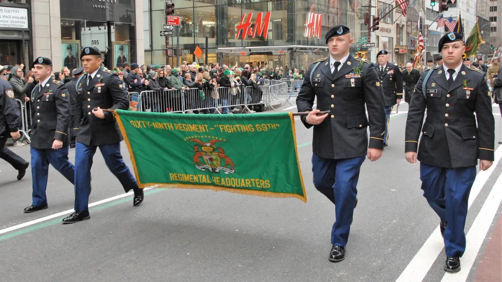 Members of the 69th Regiment hold a banner and march on S. Patrick's Day.