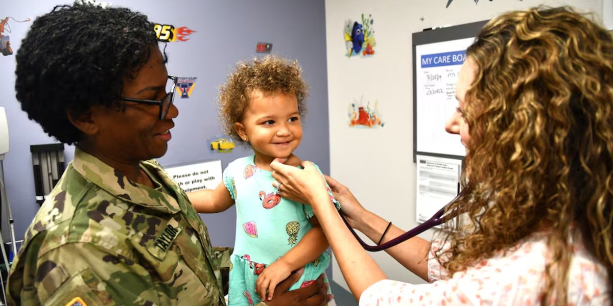 A nurse listens to a patient with a stethoscope.