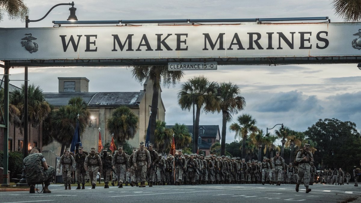 Soldiers marching under Parris Islands “We Make Marines Sign”