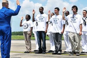 A group of 8 recruits takes the oath of enlistment.