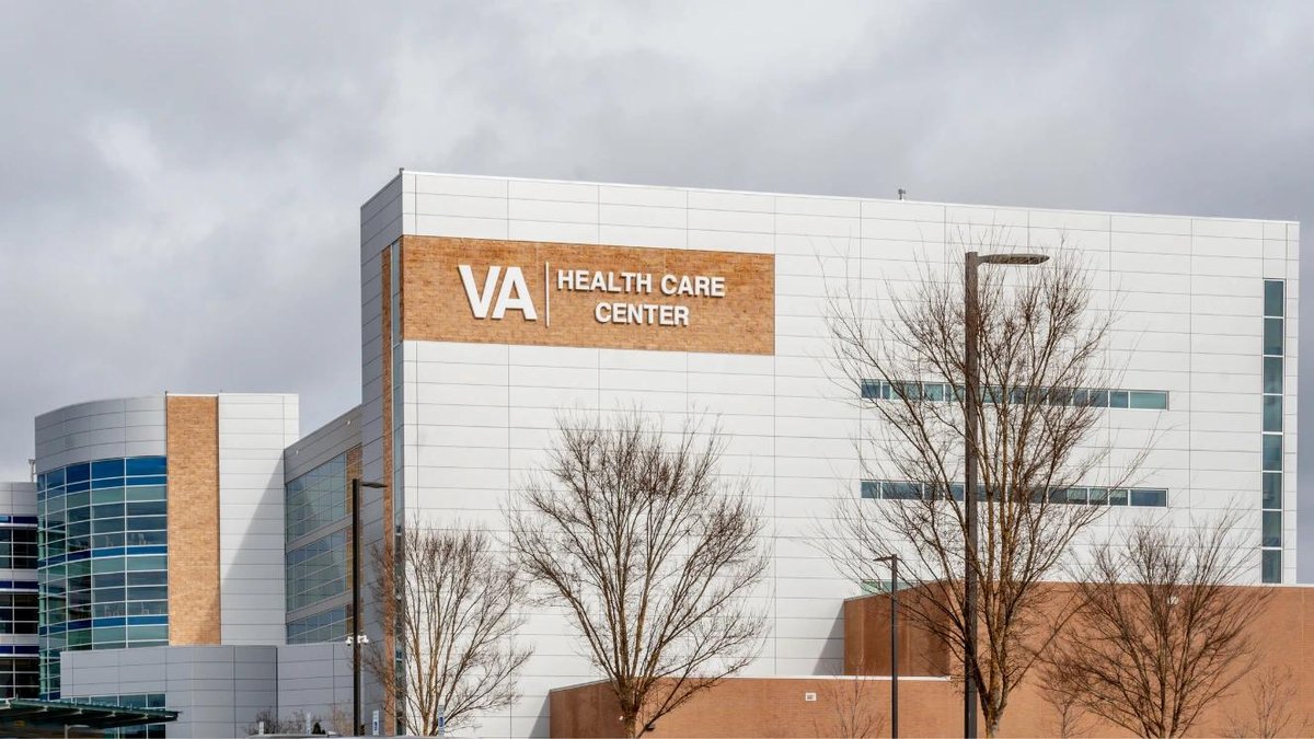 VA Health Care Center building exterior with visible signage and leafless trees.