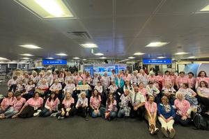 The entire group of veterans in the All-Woman Honor Flight pose with the pilot.