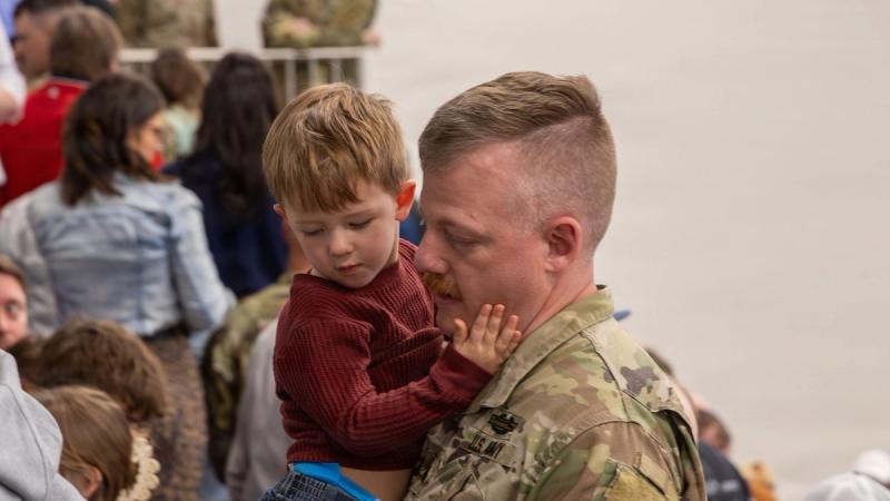 A Nebraska Army National Guard Soldier says goodbye to a young family member following a send-off ceremony at Lincoln Northwest High School in Lincoln, Nebraska, April 11, 2026.