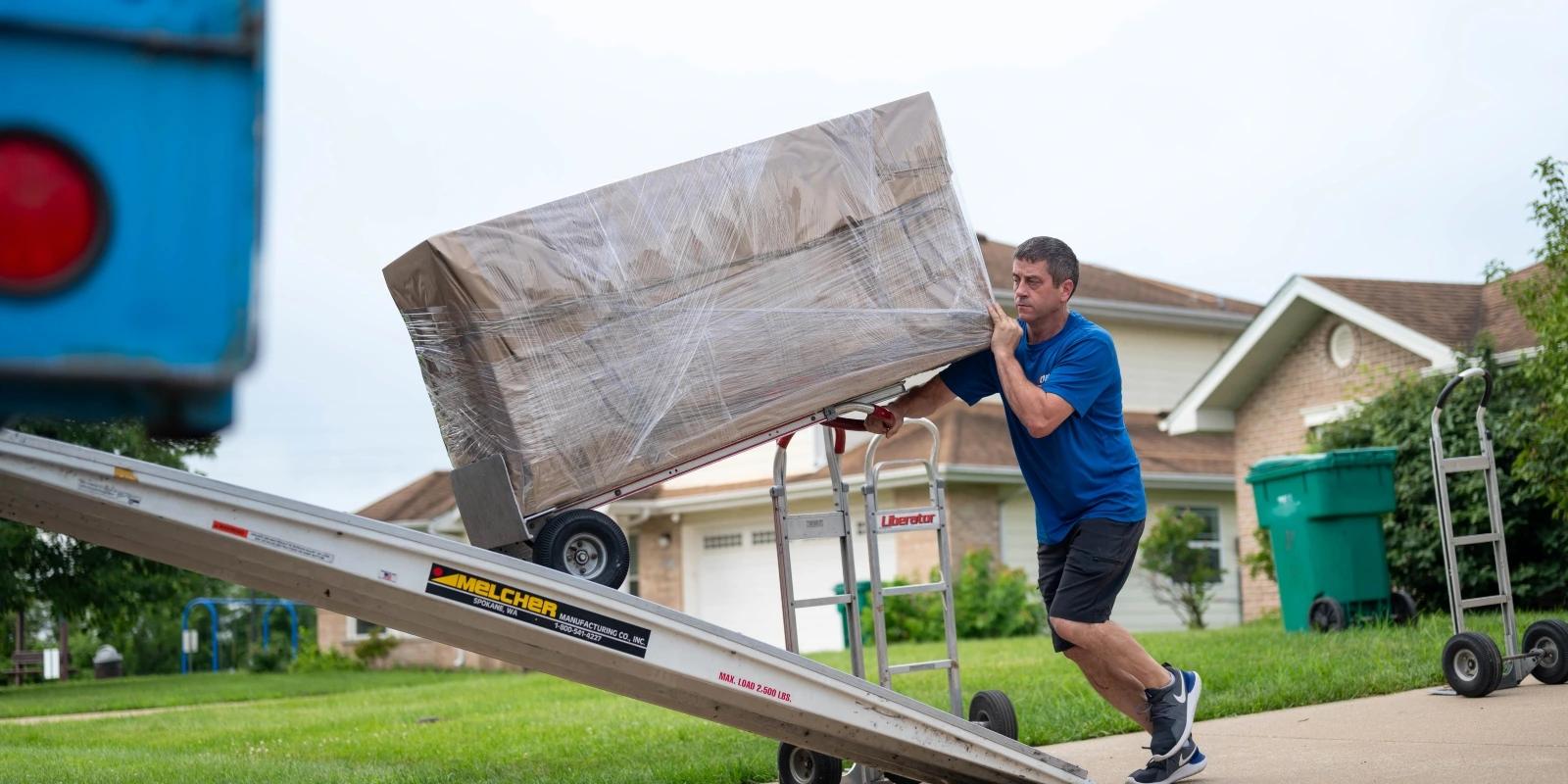 A mover loads boxes into the truck for transport to the next duty station during a Permanent Change of Station on Scott Air Force Base, Illinois.