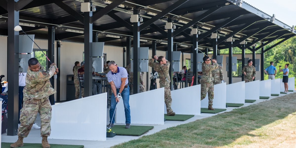 U.S. Airmen and civilians practice their golf swing during the Toptracer ribbon-cutting event at Joint Base Andrews, Md., June 26, 2024. Toptracer provides various interactive activities to golfers in order to help improve their game.