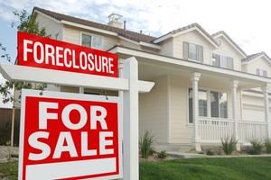 House in Foreclosure has sign in front.