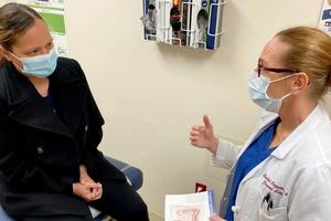Doctor talks to a patient about colorectal screening.