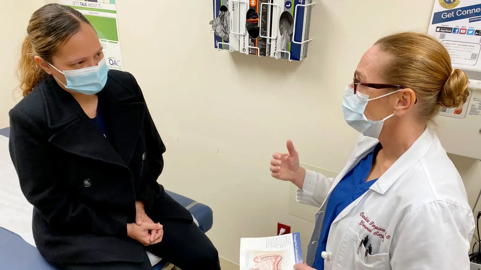 Doctor talks to a patient about colorectal screening.