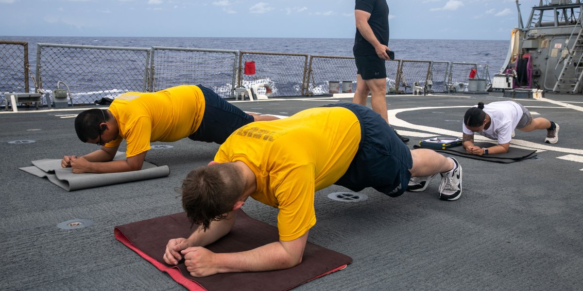 Sailors participating in a mock physical fitness test.