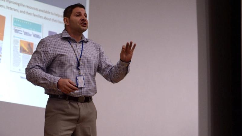 A Veterans Affairs representative briefs U.S. Airmen about educational benefits in the base theater at Spangdahlem Air Base, Germany, March 24, 2014.