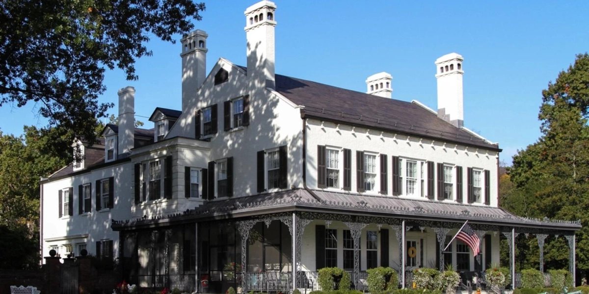West Point historic building with American flag and porch in daylight