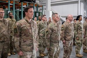 Uniformed recruits in formation indoors.