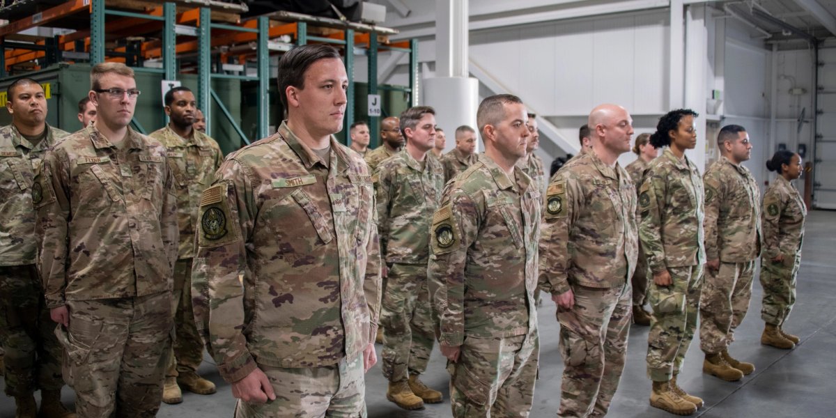 Uniformed recruits in formation indoors.