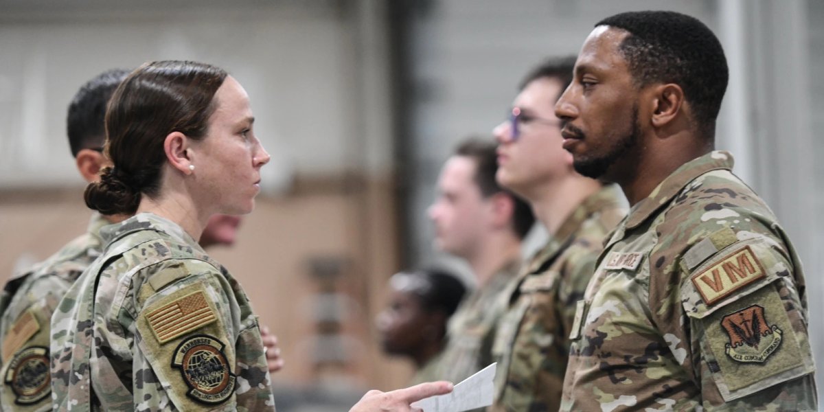 Maj. Caitlin Oviatt, 55th Logistics Readiness commander, inspects a shaving waiver during an open ranks inspection on July 9, 2024.