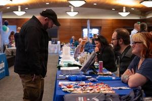 Veteran looks at brochures at a job fair.