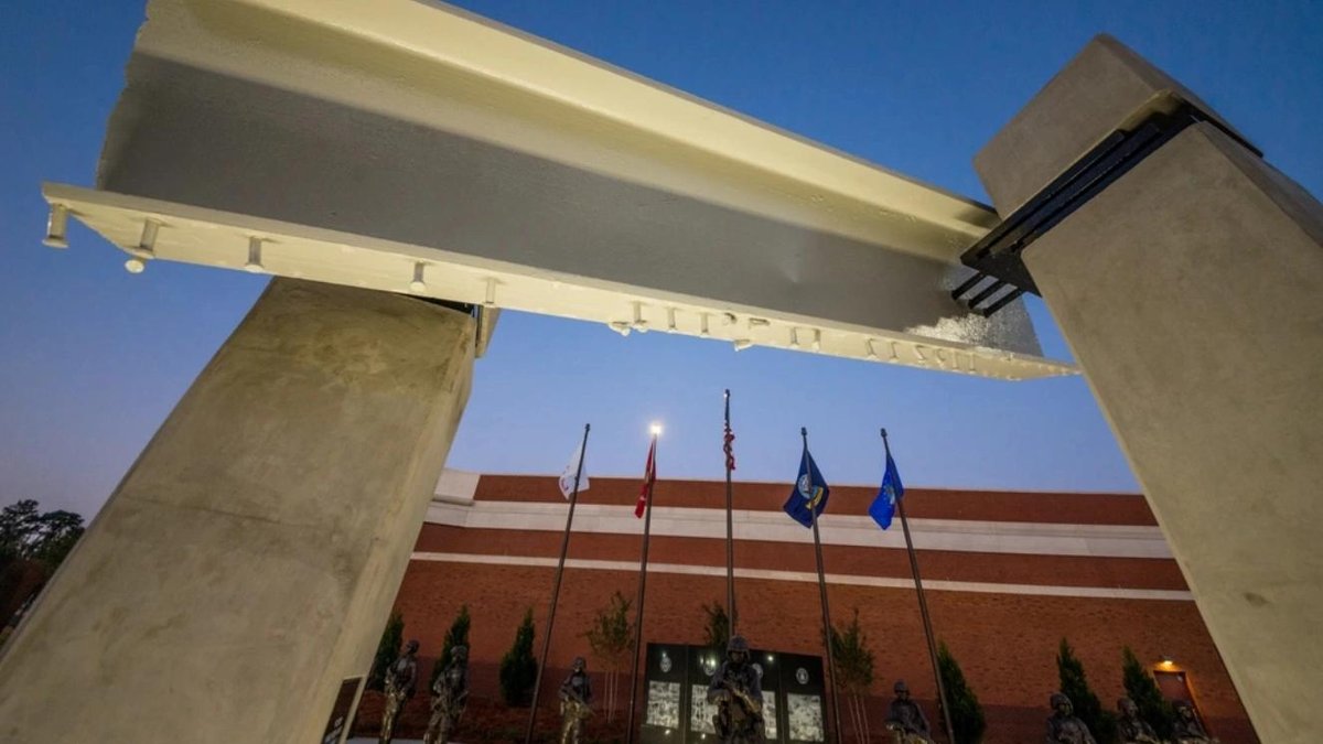 Global War on Terrorism Memorial structure with flags at dusk, designed by Kengo Kuma.