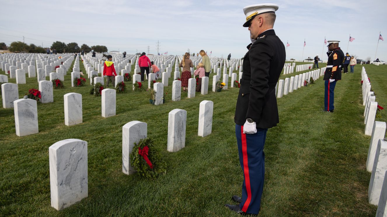 U.S. Marine Corps Col. R. Erik Herrmann, the commanding officer of Marine Corps Air Station Miramar, salutes a headstone at the Wreaths Across America event at Miramar National Cemetery, San Diego.