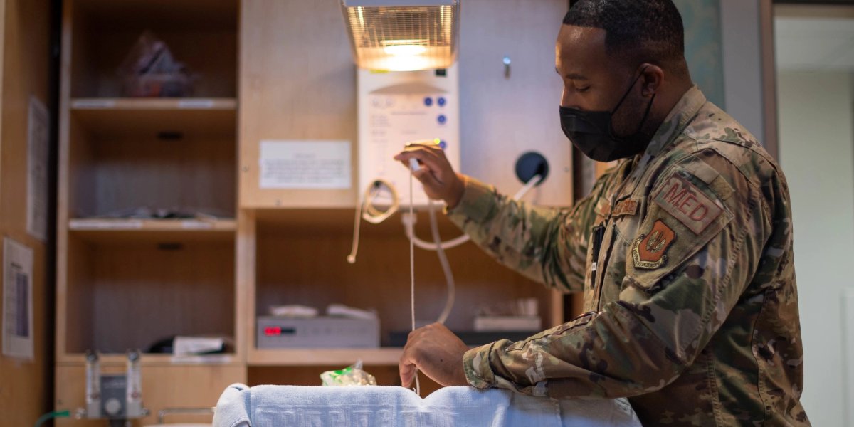 A serviceman works in the maternity ward scene from his side.