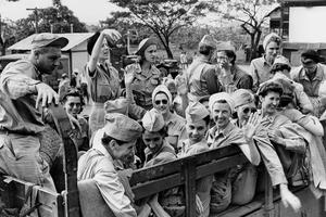Vintage photo of of nurses and servicemen in a truck.