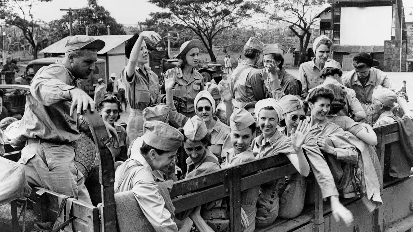 Vintage photo of of nurses and servicemen in a truck.