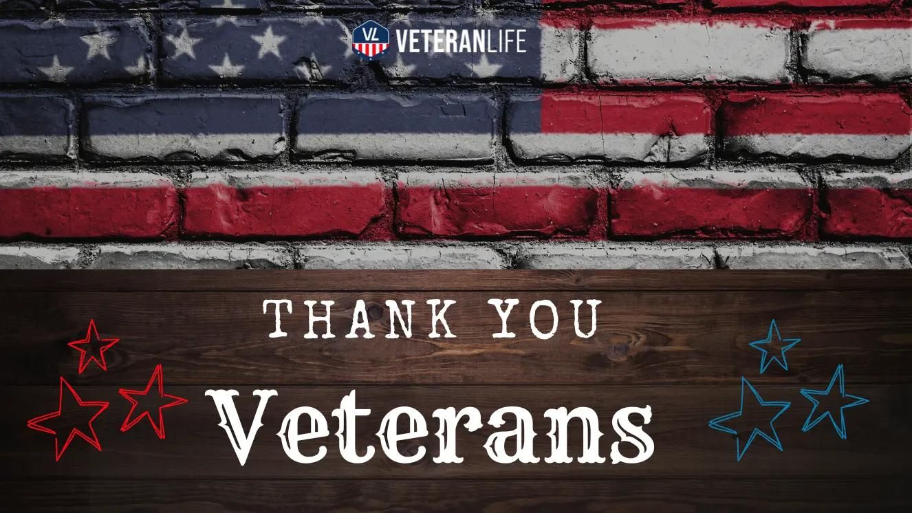 American flag painted on brick wall with "Thank You Veterans" text over wooden background