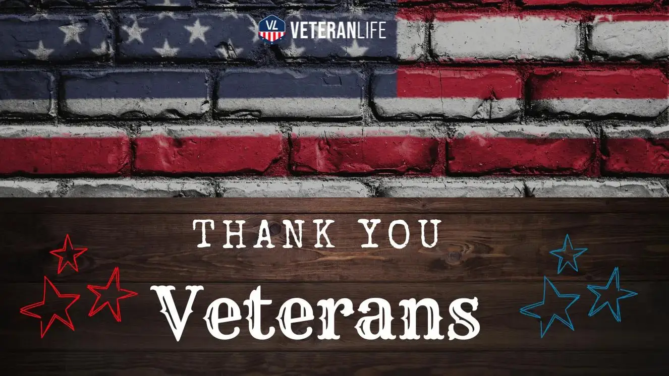 American flag painted on brick wall with "Thank You Veterans" text over wooden background