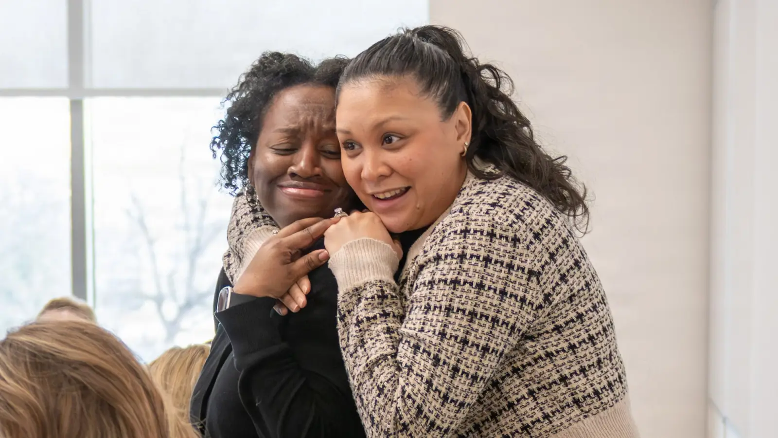 Two military wives hug in support.