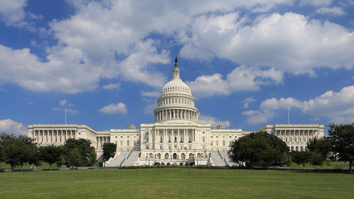 U.S. Capitol building under blue sky with clouds