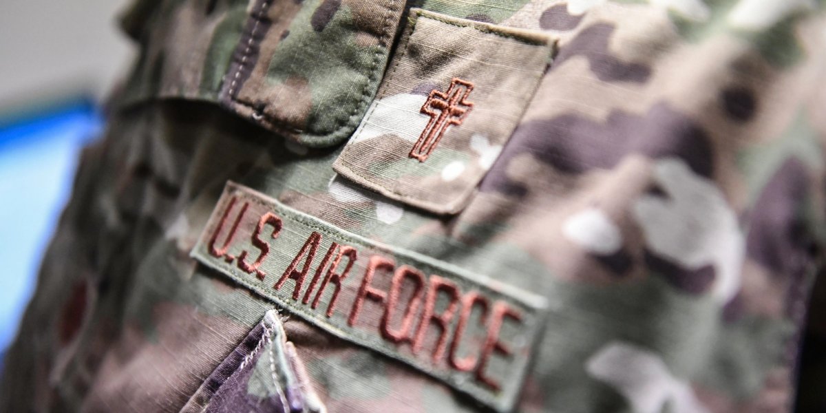 Close-up of a uniform with an embroidered cross.
