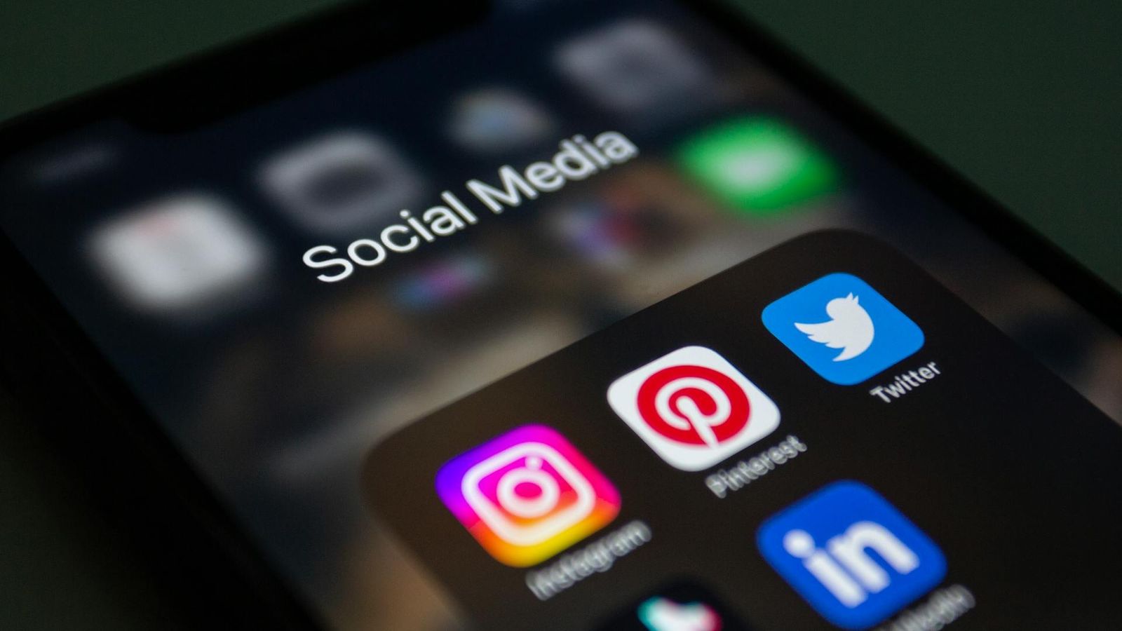 Close-up of a phone screen’s social media icons.