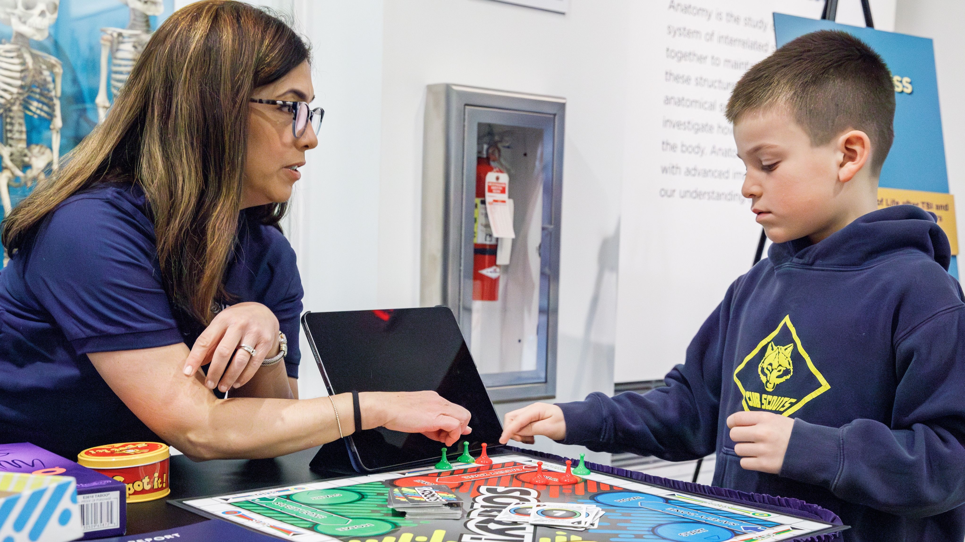 Therapist and young boy play a game.