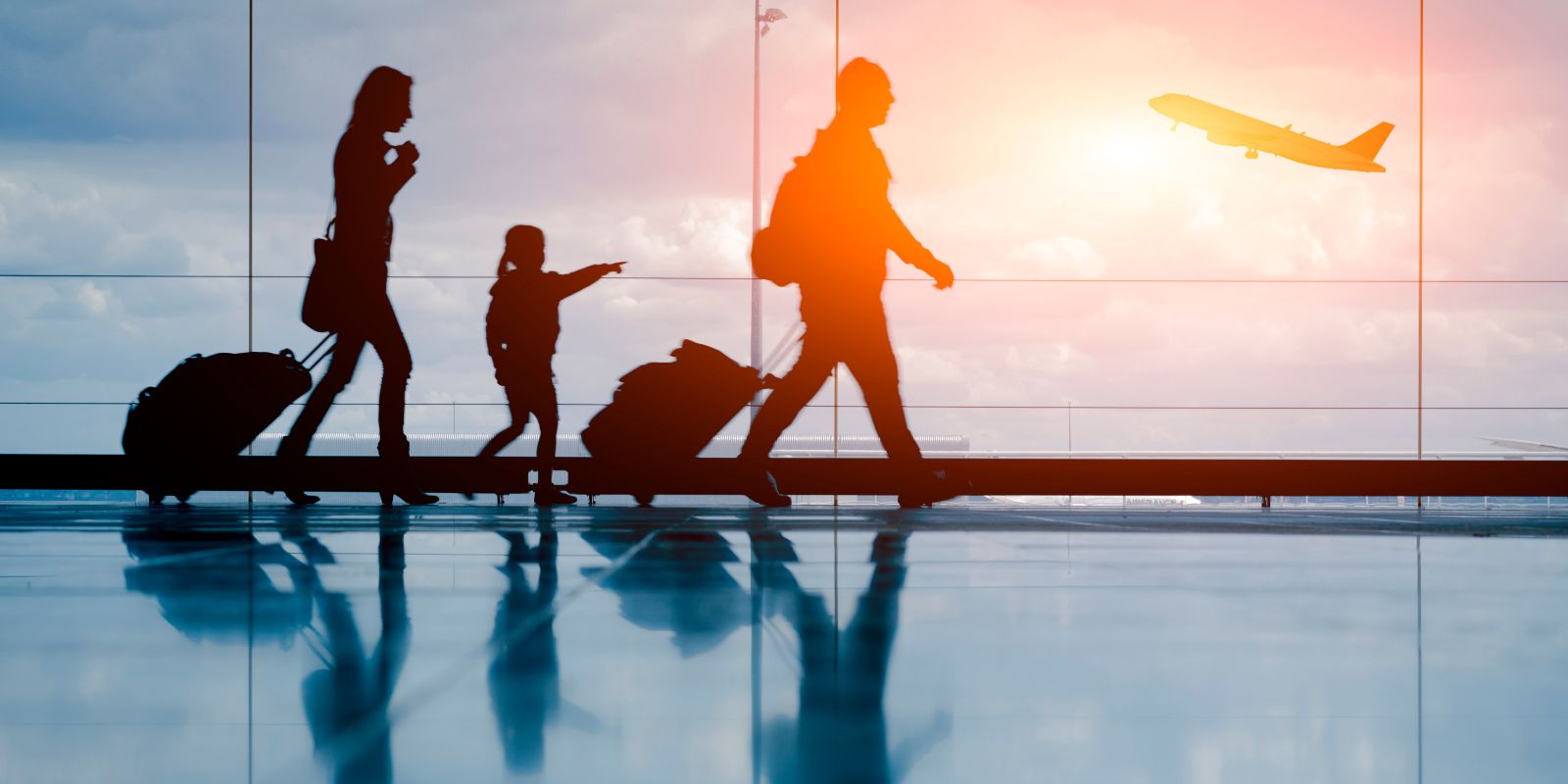 Sihouette of young family and airplane.