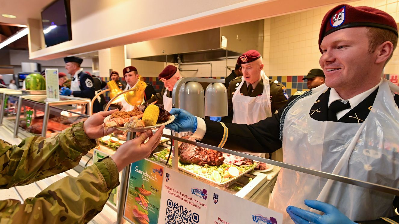 Capt. Grant Lockwood hands over a hefty plate during an early Thanksgiving meal for service members and families, Department of Defense civilian workers and military retirees at the Wilderness Inn, Nov. 26, at Joint Base Elmendorf-Richardson. 