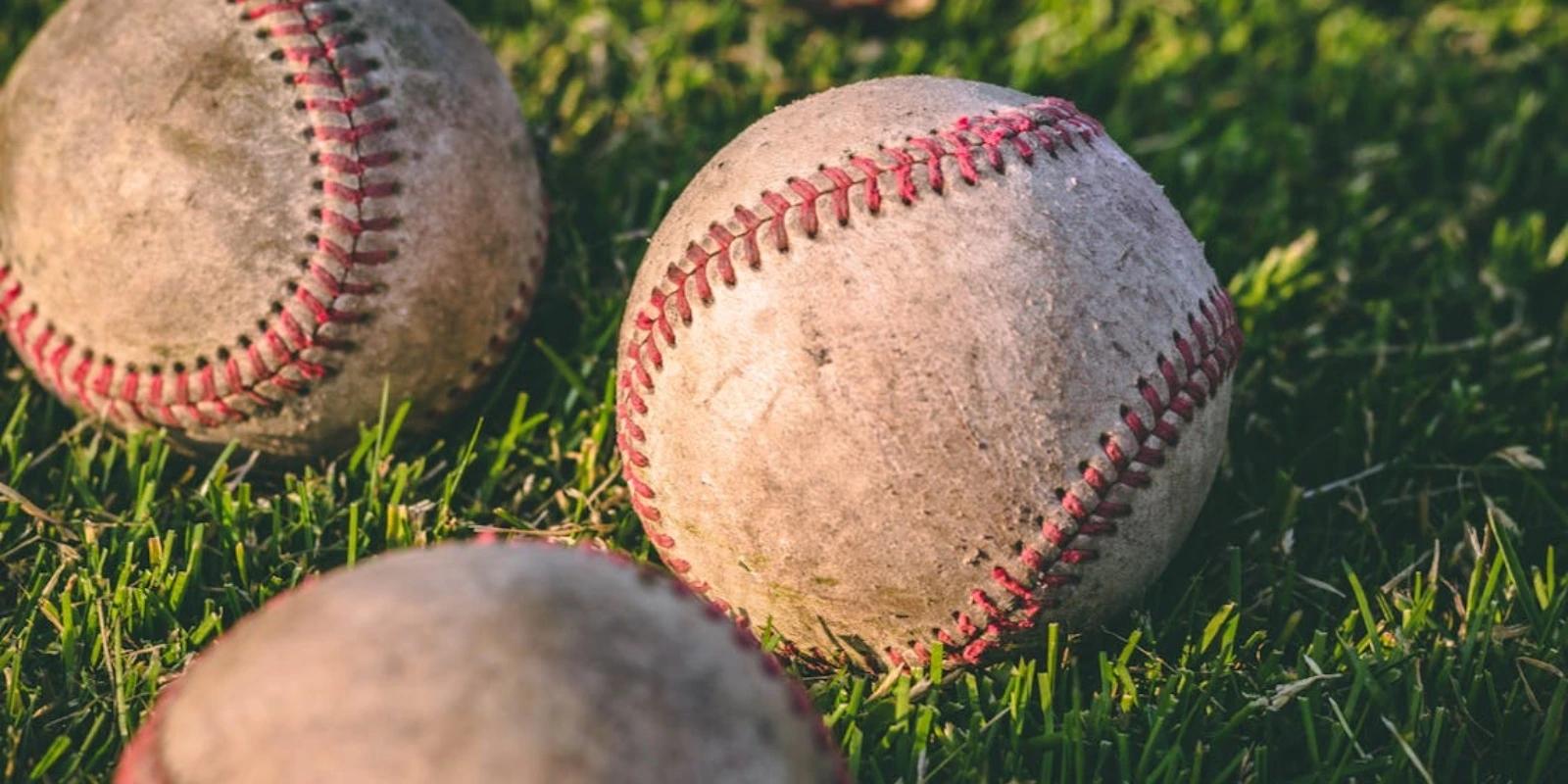Baseballs on the grass.