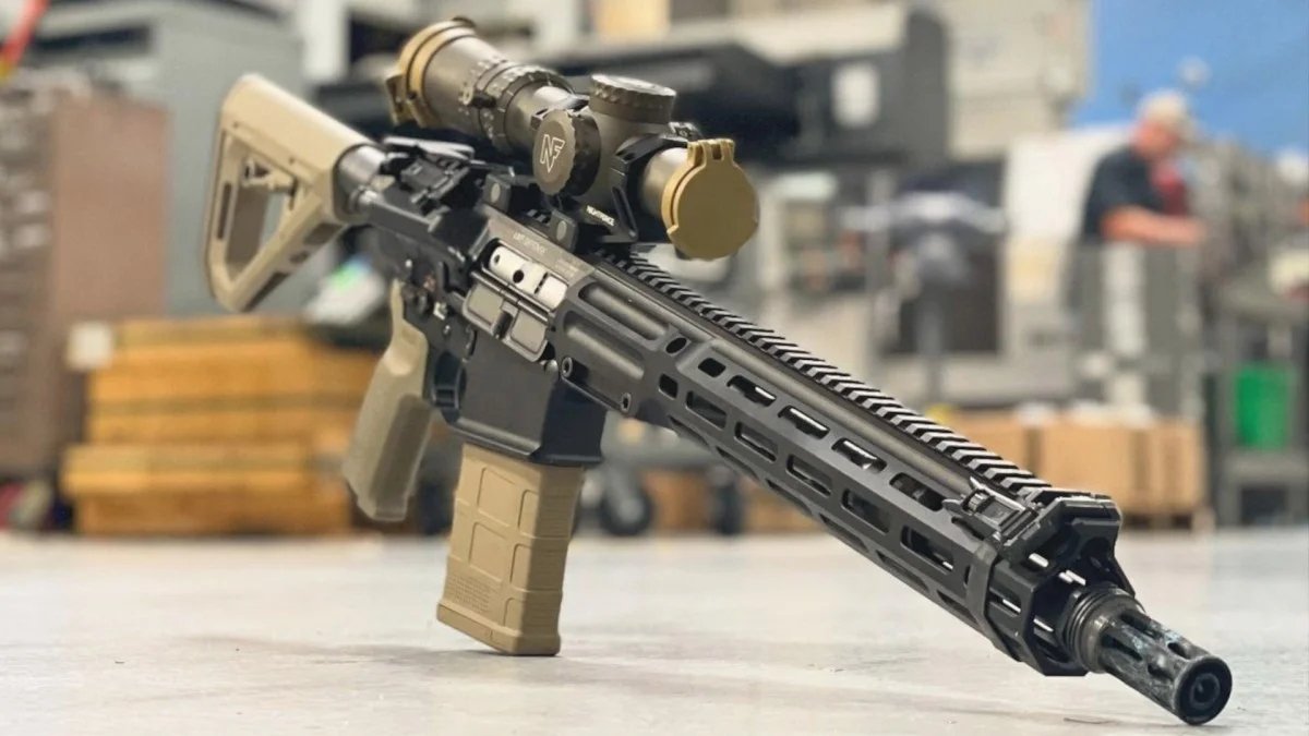 A new military rifle displayed on a table top.