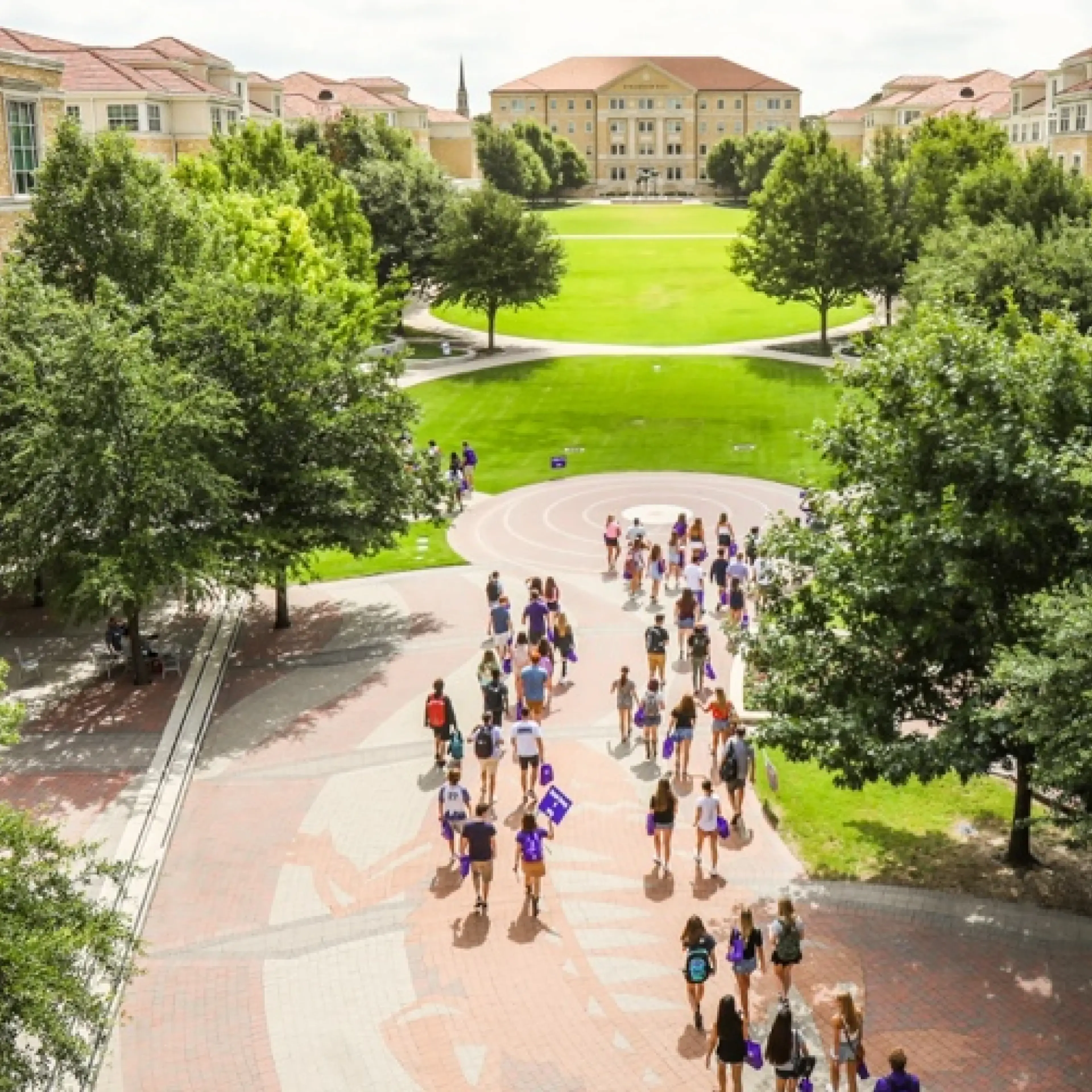 Texas Christian University campus with students walking across quad