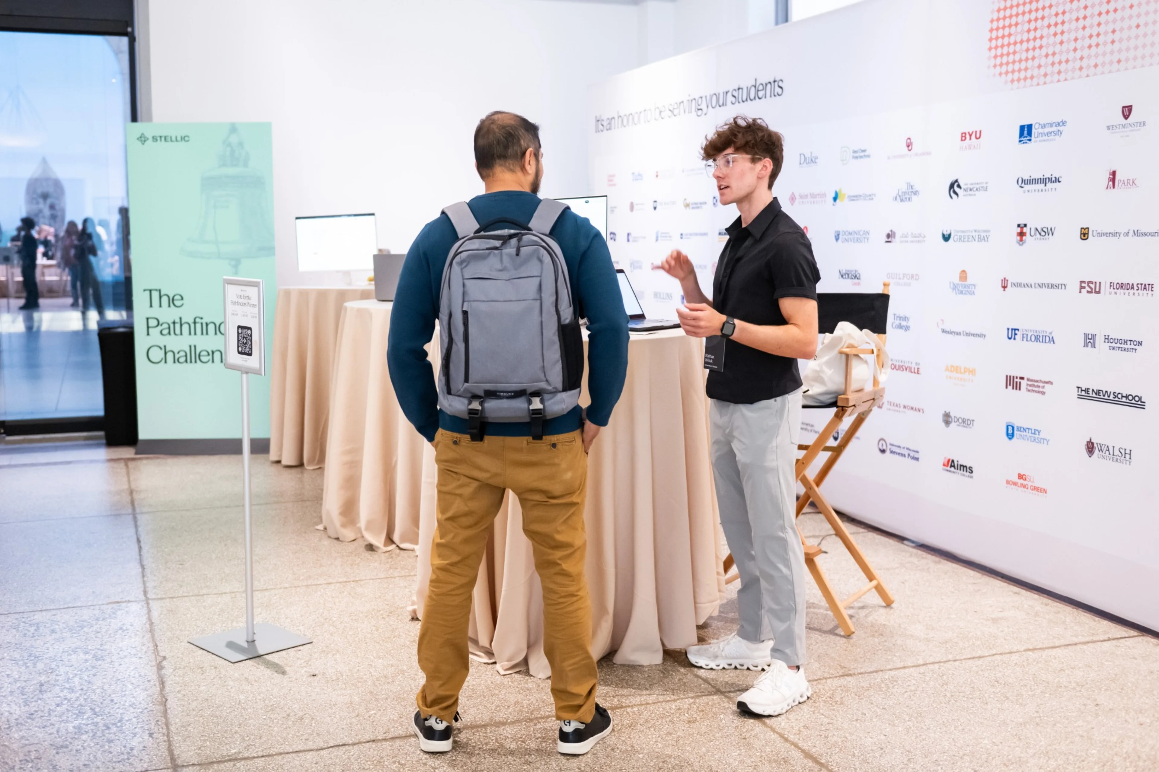 Nathan Wituk talking with an attendee at the Pathfinders booths