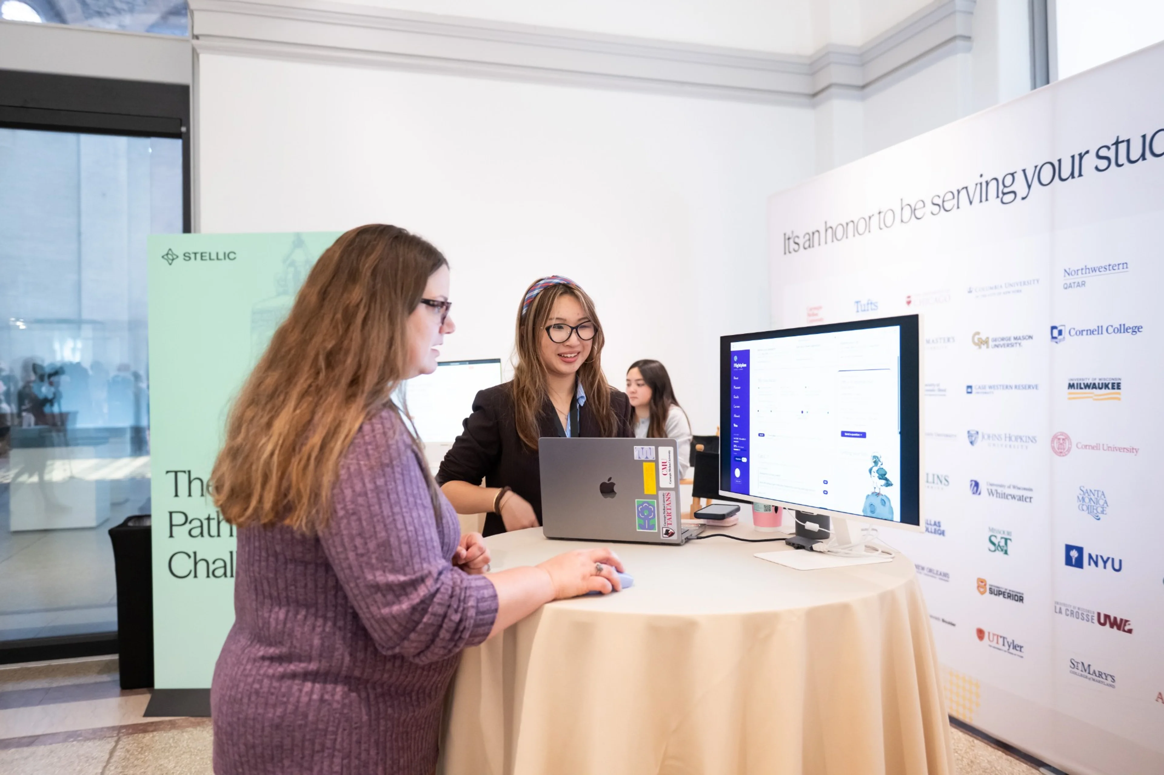 A Flightplan finalist walking a Summit attendee through the app