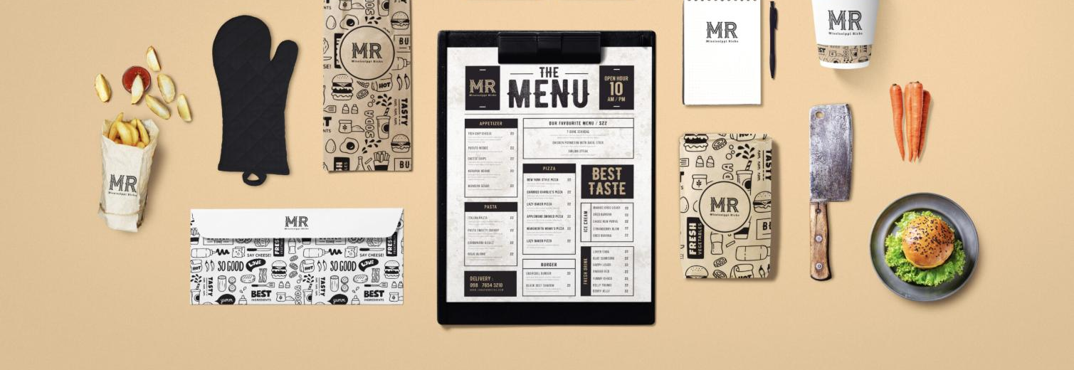 A Looka brand-kit mockup for a fictional 'MR - Mississippi Ricks' restaurant: the generated MR monogram logo applied across a printed menu, patterned takeout bags, a coffee cup, a spiral notepad, an envelope and food packaging arranged on a tan surface.