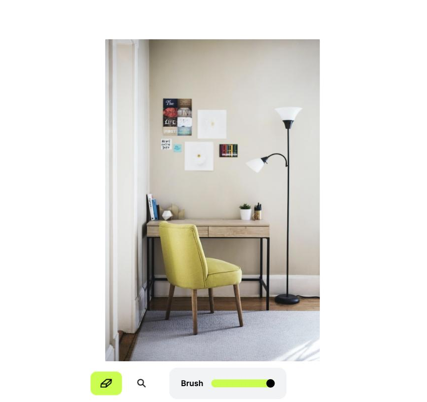 Cleanup.pictures editor open with a sample interior photo of a desk, chair and a tall black floor lamp, showing the brush tool and brush-size slider ready to mark an object for removal.