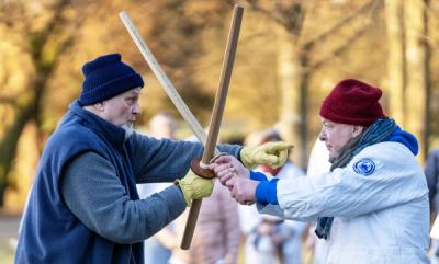 Two senior aikido practitioners engaged in bokken sword practice at advanced seminar