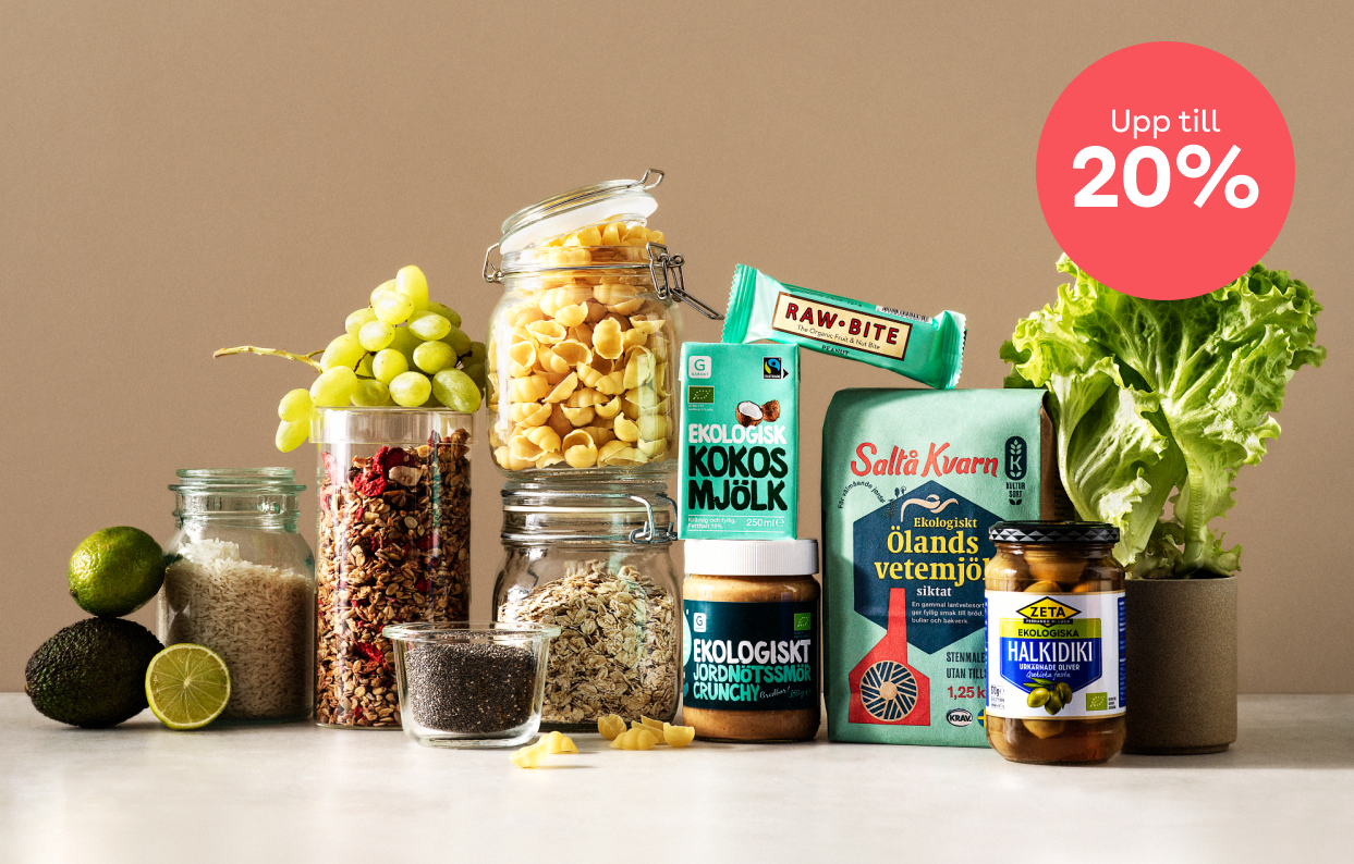Flera olika produkter och burkar med råvaror står uppstaplade mot en mörk beige bakgrund. En röd splash med 20% ligger uppe i bildens högra kant. 