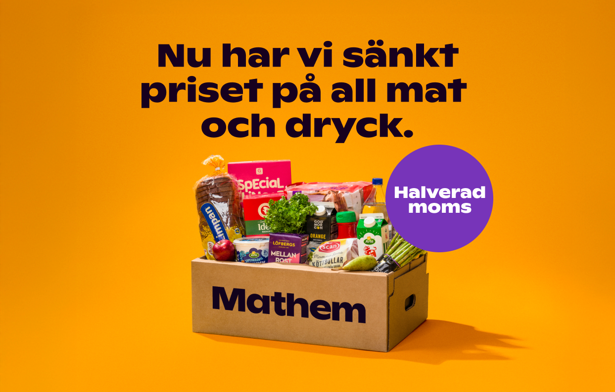 På bilden syns en Mathemlåda fylld med varor mot en orange bakgrund och texten "Vi halverar matmomsen redan nu"