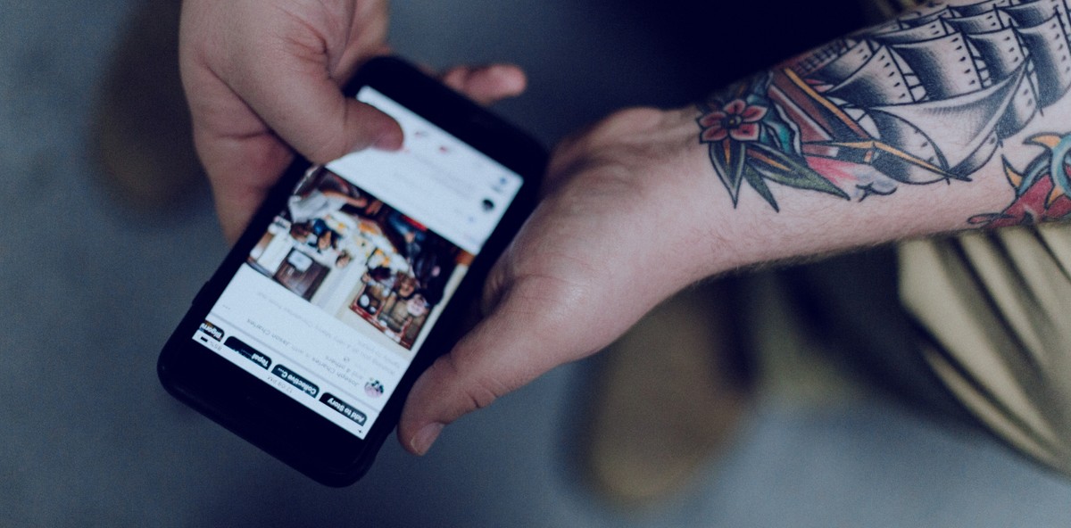 Man interacting with social media on a mobile device