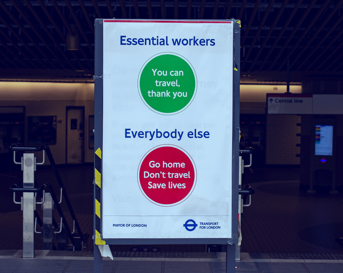 Sign that reads "Essential workers - you can travel. thank you" and "Everybody else - Go home. Don't travel. Save lives"