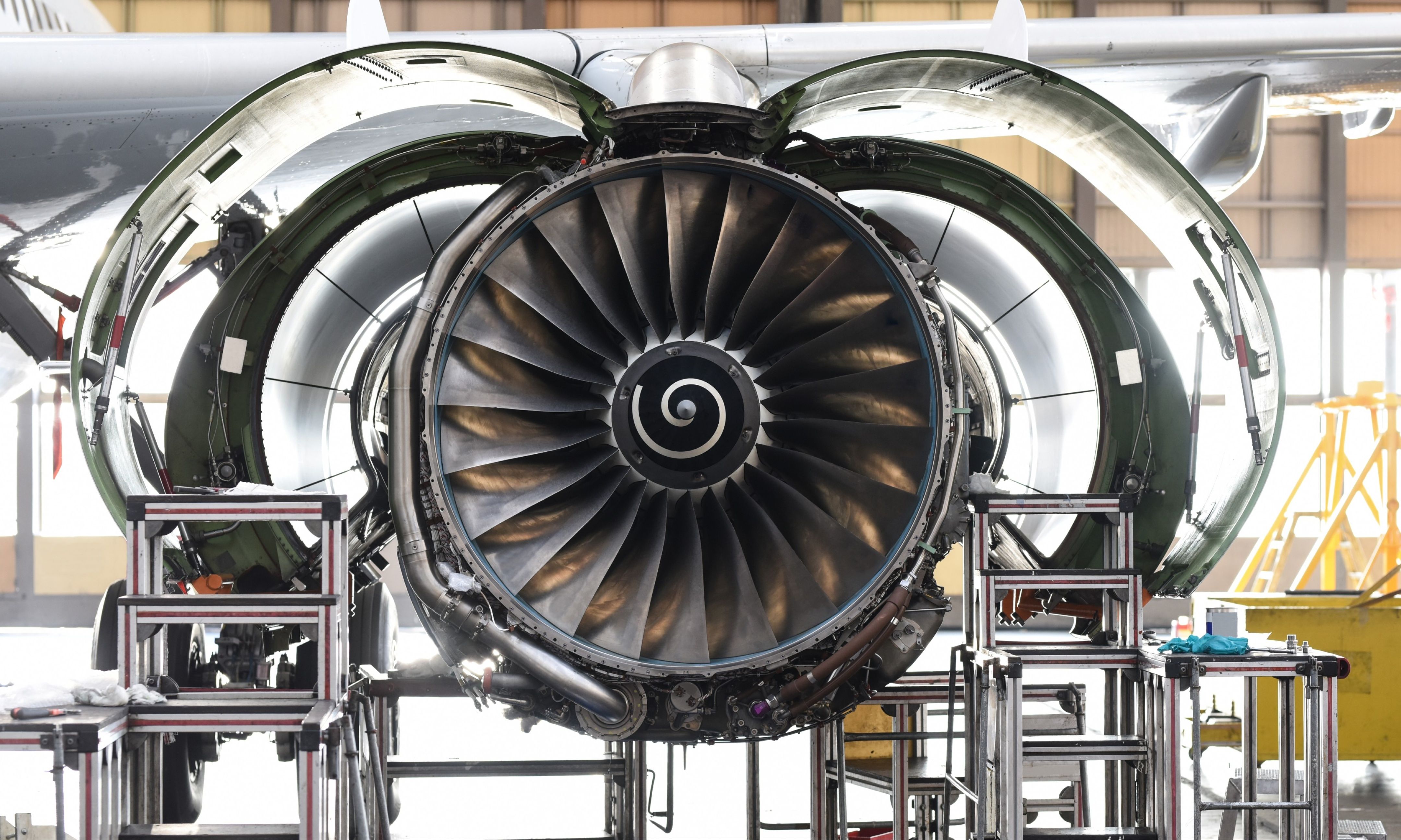 Aircraft engine with its cowling open in a manufacturing facility